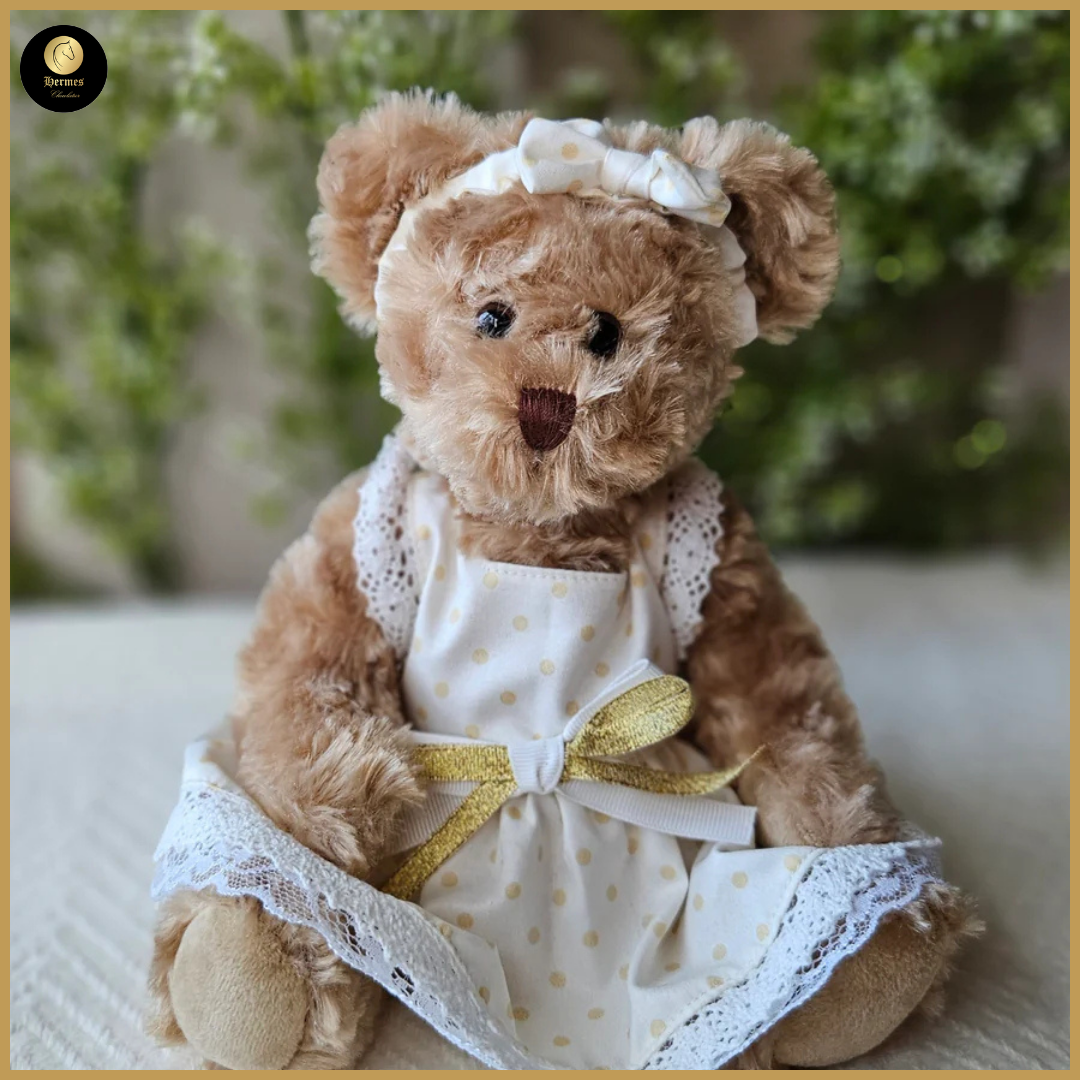 Meisjesbeer met beige jurkje en goud 25cm