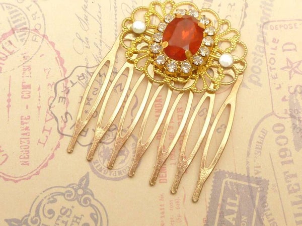 Kleiner Haarkamm mit rotem Schmuckstein und klarem Strass goldfarben
