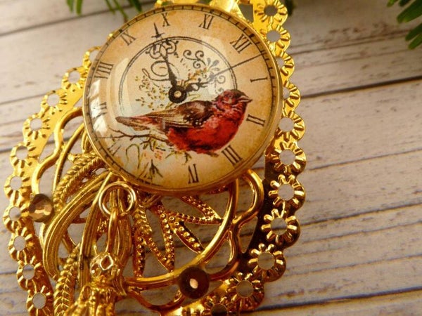 Winterlicher Deko-Anhänger mit Vogel und Ziffernblatt Tropfenform goldfarben