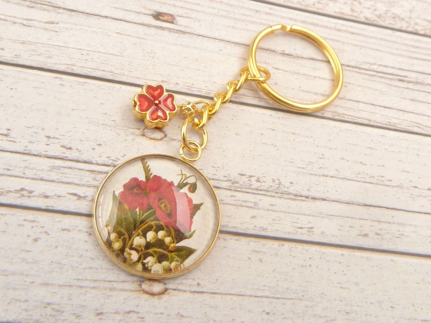 Schlüsselanhänger in goldfarben mit Mohn und Maiglöckchen Motiv Glascabochon