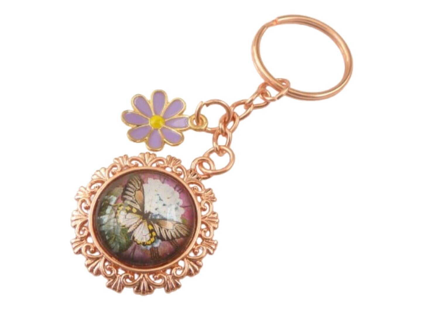 Schlüsselanhänger in rotgold mit Schmetterling Motiv und Emaille Blüte