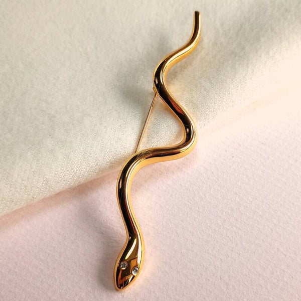 Slingerende goudkleurige slang broche 90s
