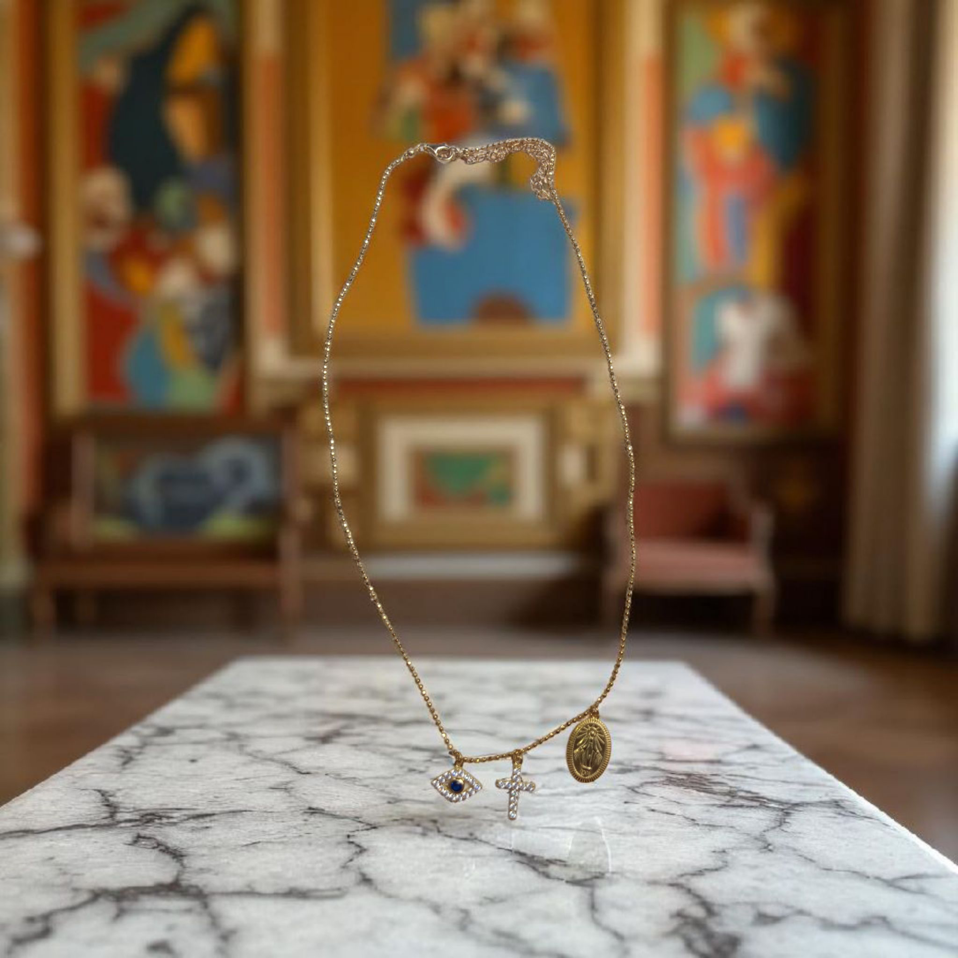 "Fear No Evil" 18 K gold Plated Sterling Silver necklace with tiny diamond studded cross, emerald evil eye and mother of God pendant