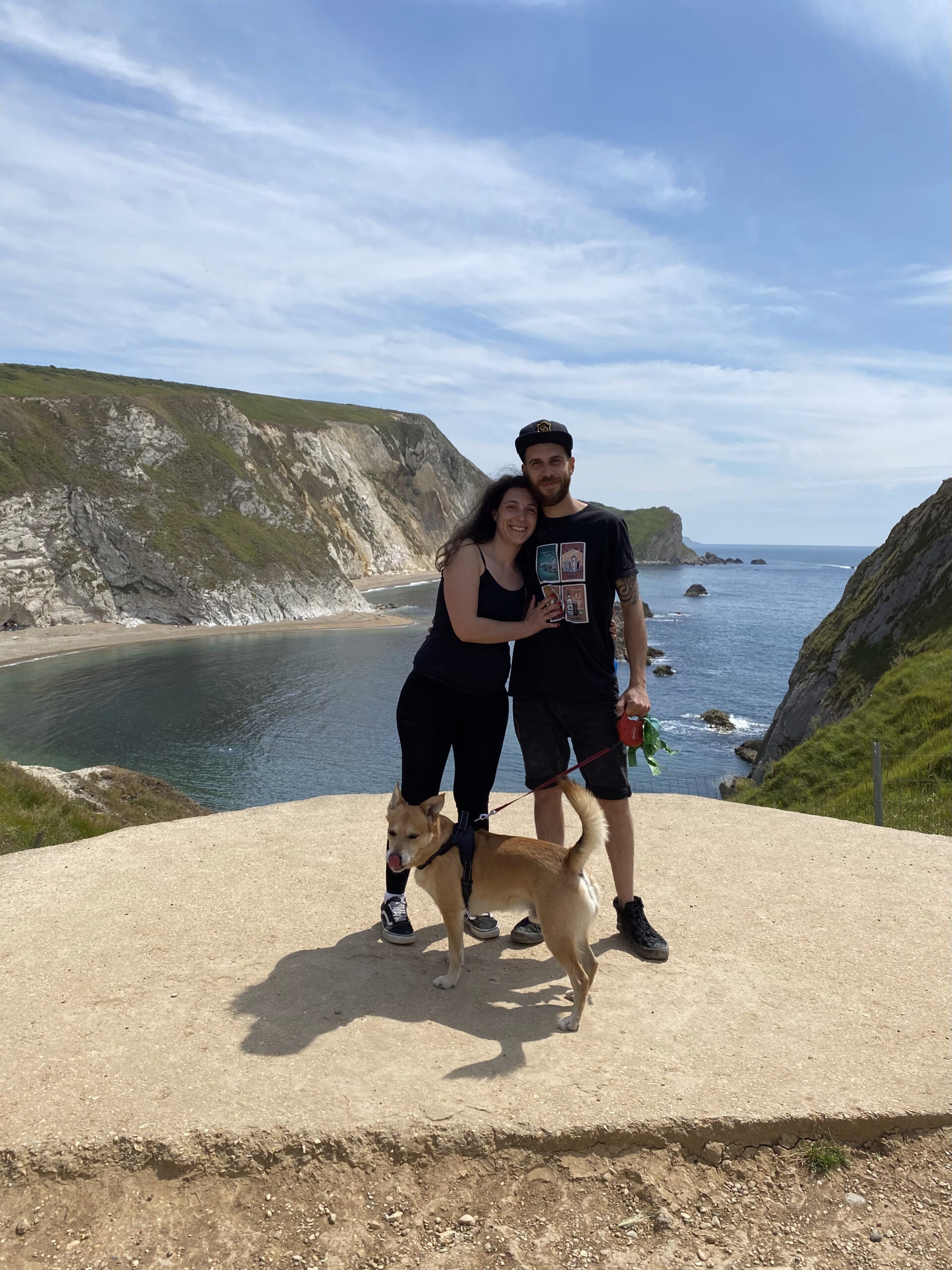 Beatrice, holistic nutritional advisor and founder of Healthy Flame by B, smiling after hiking in Dorset, with my partner Luca and dog Ares.