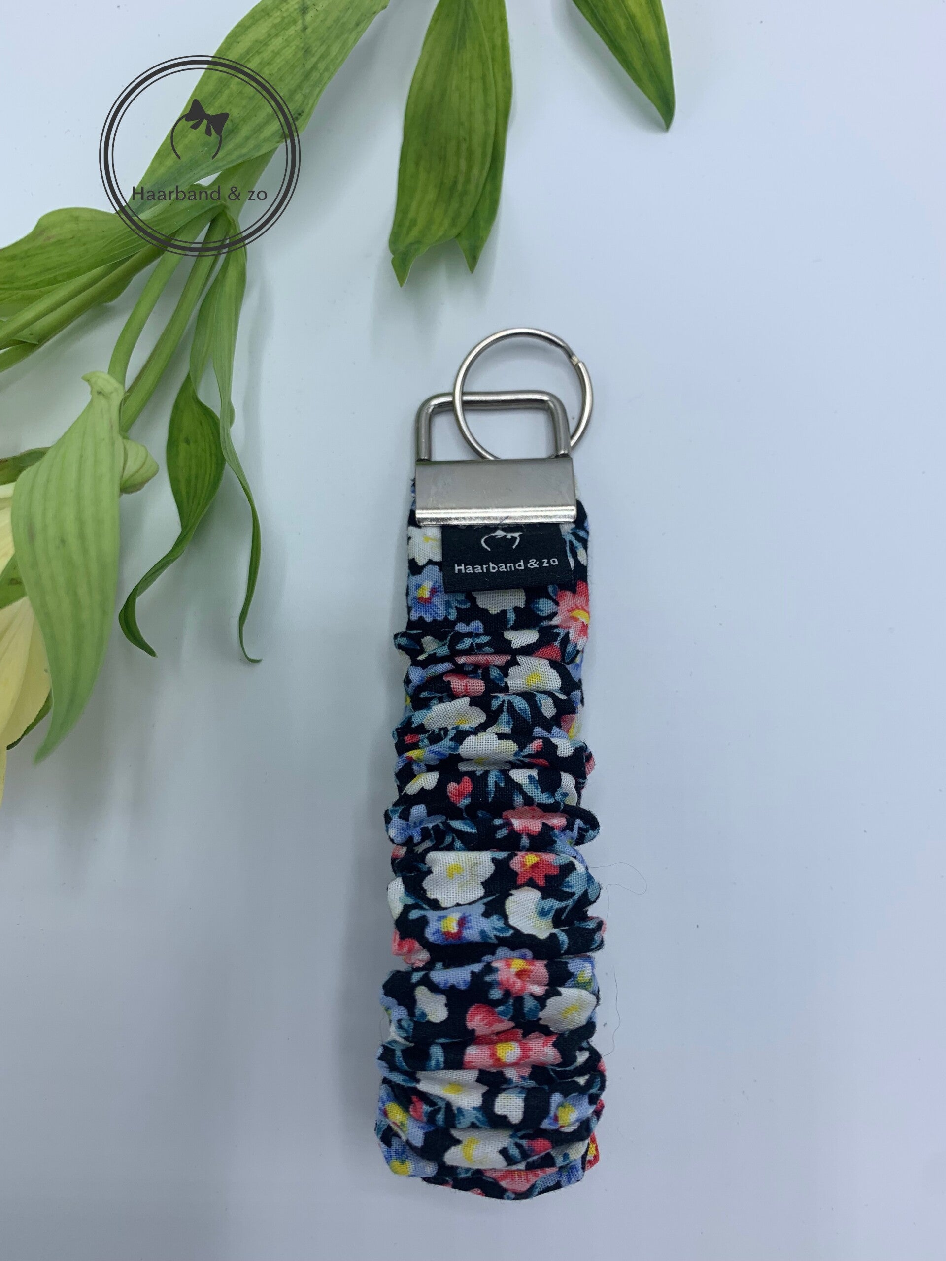 Haarband & zo, sleutelhanger/scrunchie wristlet (polsband) in blauw/roze bloemenprint met zwarte ondergrond (art.nr. SH 01-03)