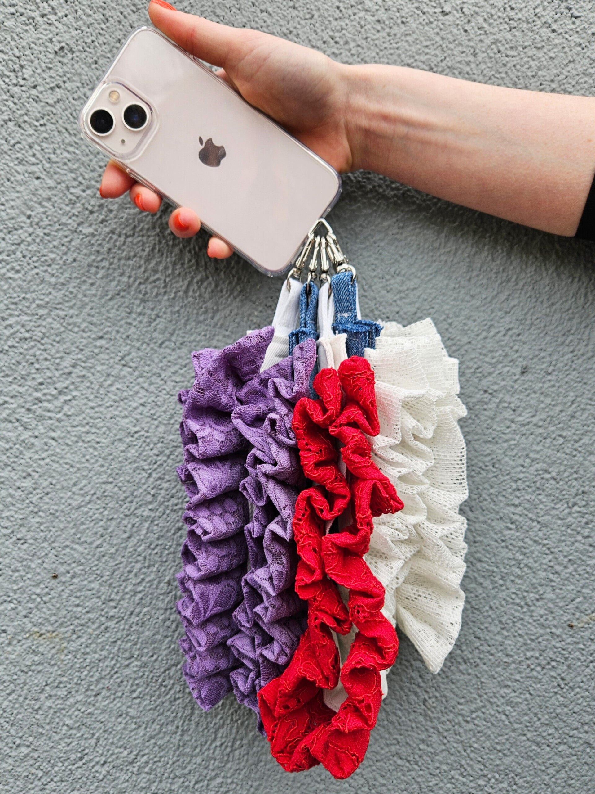 one phone with four wrist wraps made from jeans and lace.