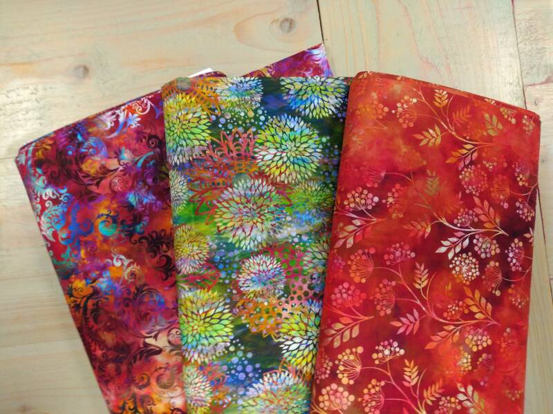 drie rollen quiltstof oranej rood groen floragraphix bloemen patroon