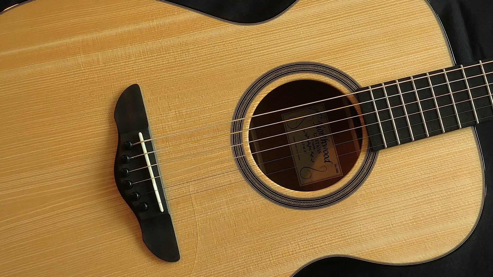 70 Series Northwood soundboard showing standard herringbone rosette and plain ebony fretboard