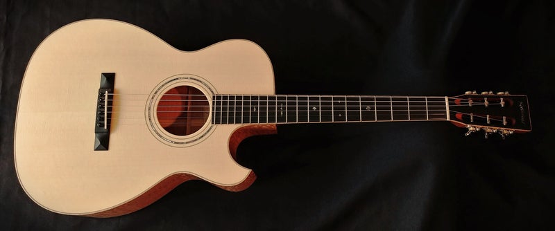 Northwood guitars custom Florentine cutaway OM with 12 fret neck, 42 style fretboard inlay, slotted headstock and quilted maple back and sides.