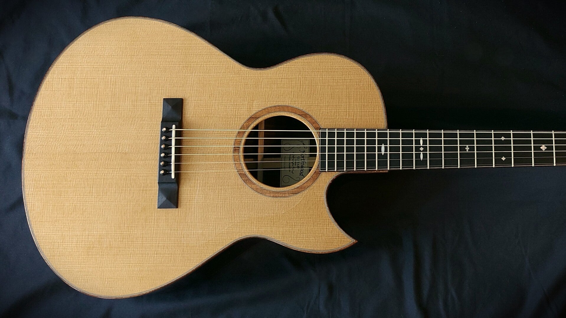 Northwood guitars Florentine cutaway Auditorium model acoustic guitar with Lutz spruce top and koa rosette.