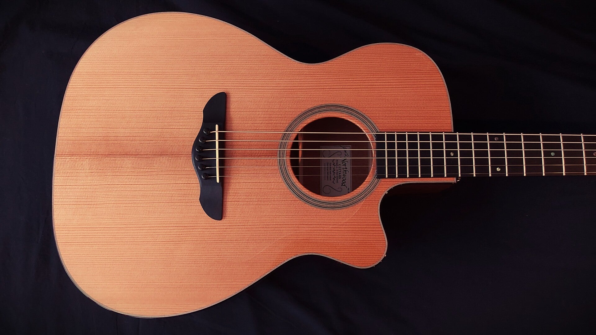 Northwood guitars Venetian cutaway OM  featuring Western Red Cedar top and herringbone rosette.