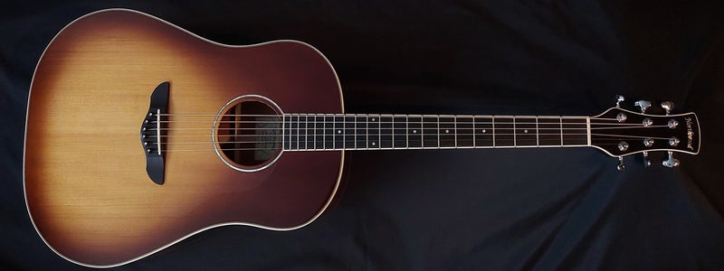 Northwood guitars slope shoulder dreadnought model acoustic guitar with sunburst finish, clear pickguard and single ring mother of pearl rosette.