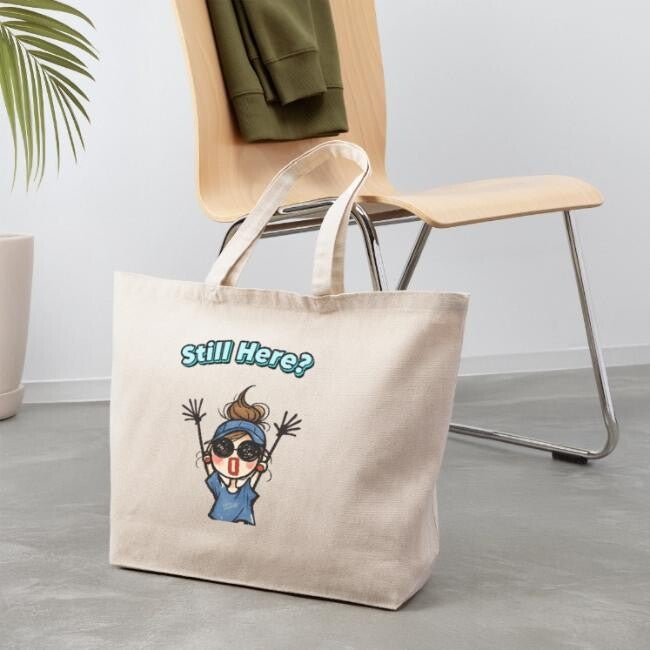 Beige tote bag featuring the “Still Here?” doodle girl illustration with expressive cartoon character and indie aesthetic style.