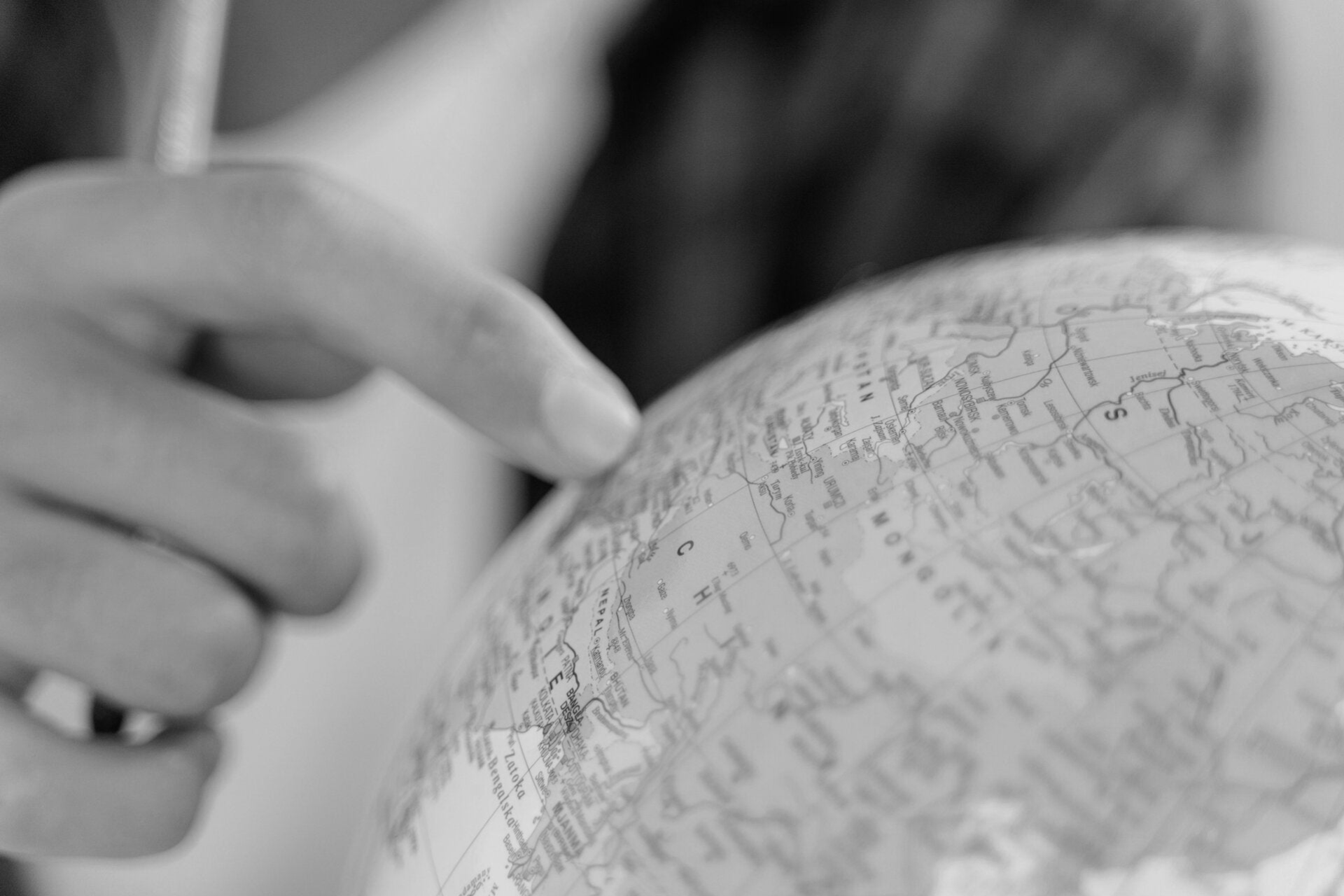 A smiling woman covers her ears.