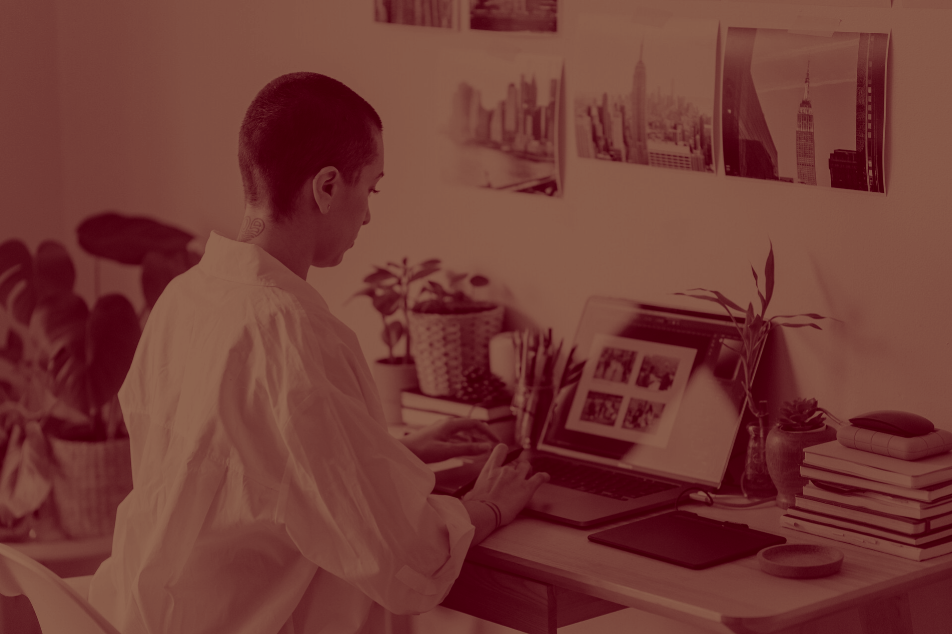 A smiling woman covers her mouth..