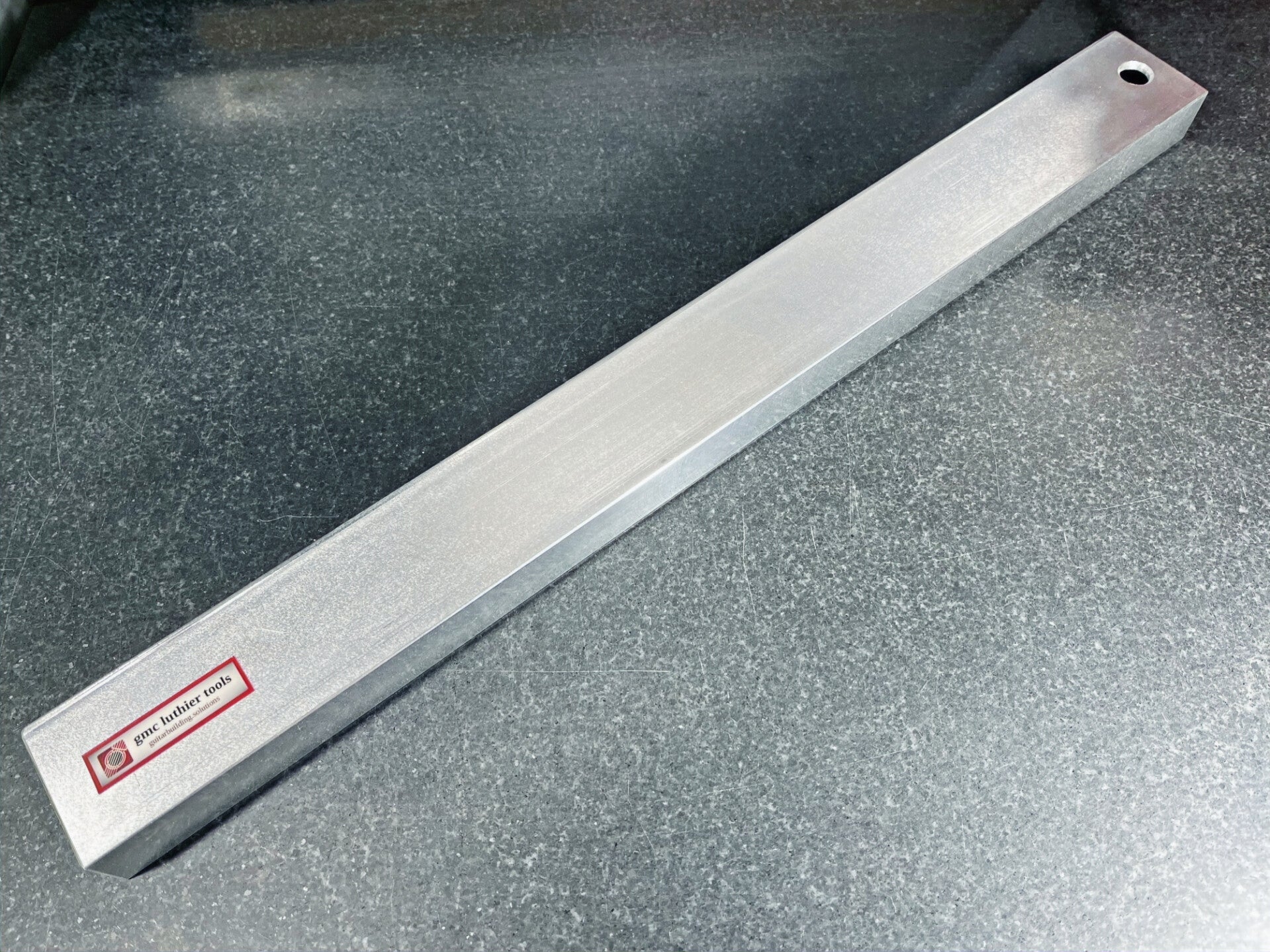 GMC Luthier Tools 19" precision aluminium fret levelling beam laying on a granite surface table.