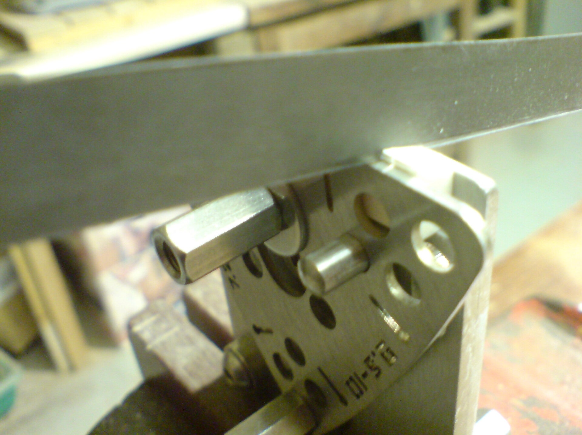 GMC Luthier Tools nut filing jig action setting plate, being used to determine the depth of filling for a string slot.