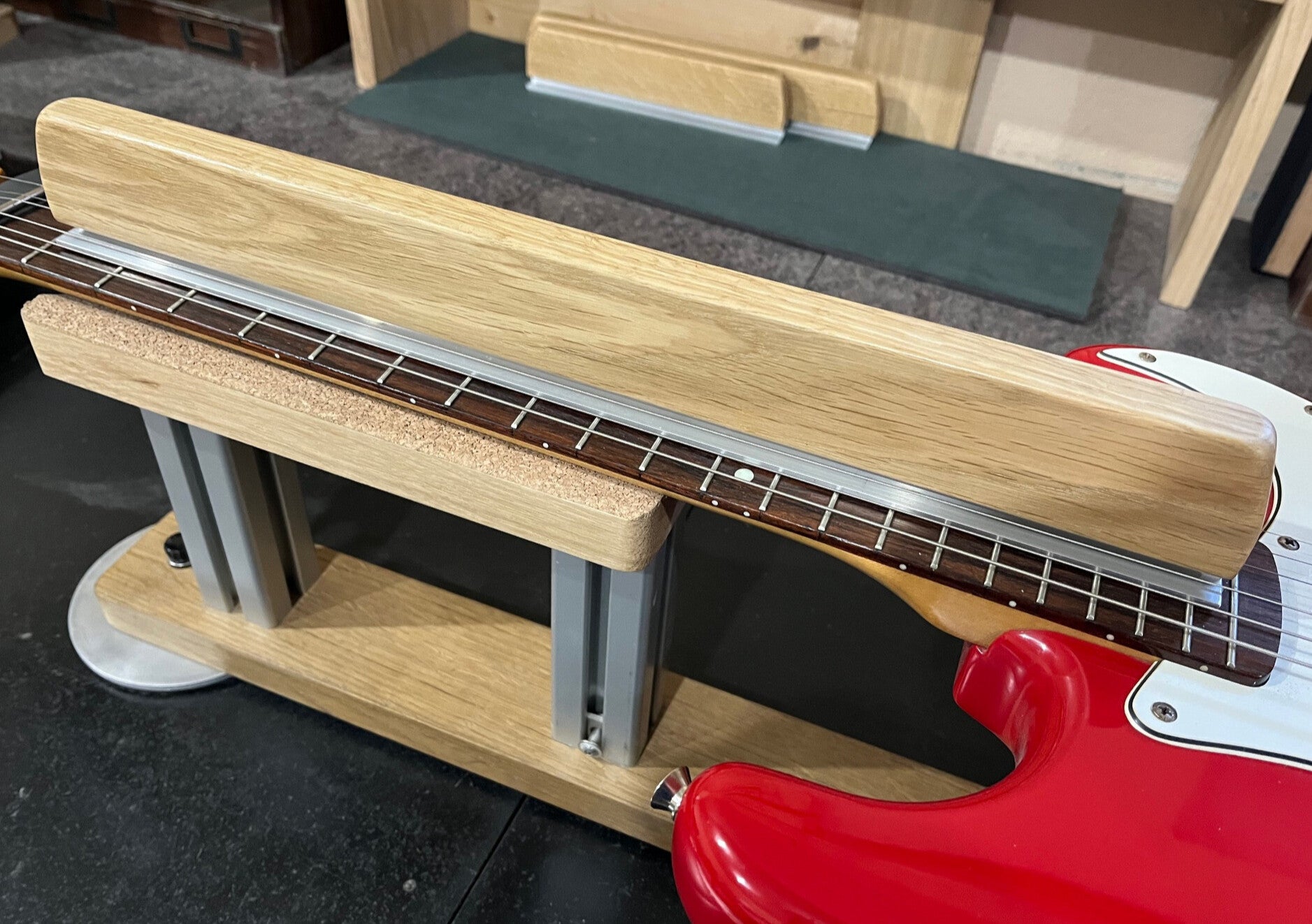 GMC Luthier Tools 16" Universal Fret Leveller being used underneath the strings on a stratocaster guitar.