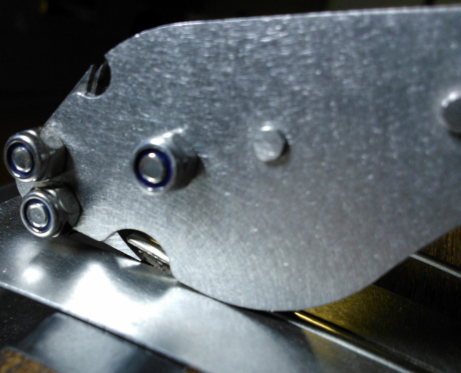 GMC Luthier Tools Fret Puller resting over a fret guard, removing a fret after prizing the end away from the fretboard.
