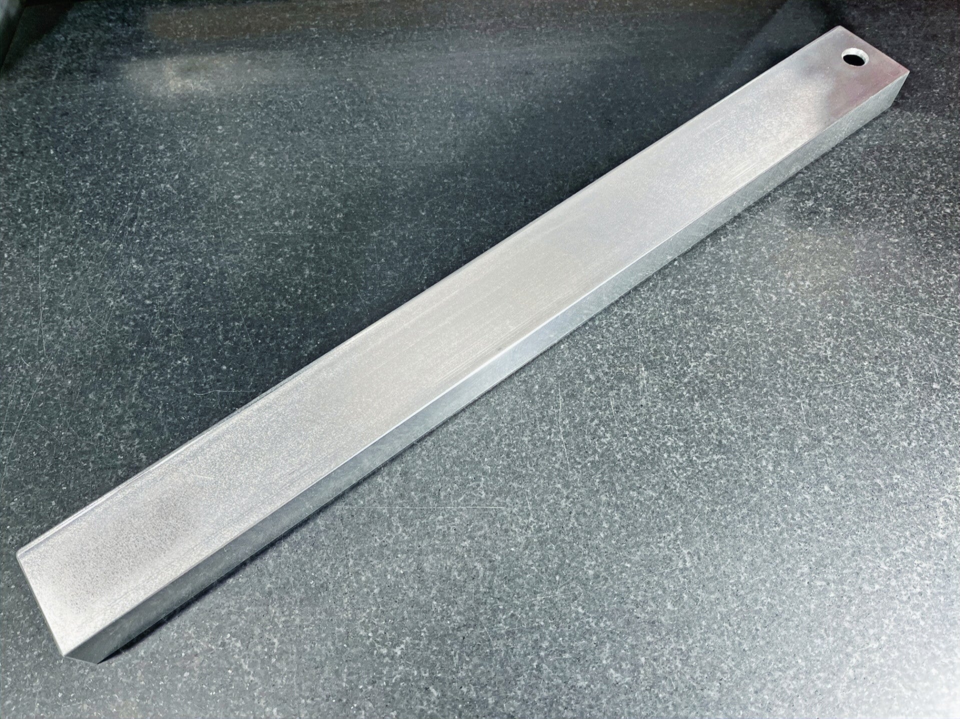 GMC Luthier Tools 19" precision aluminium fret levelling beam laying on a granite surface table.