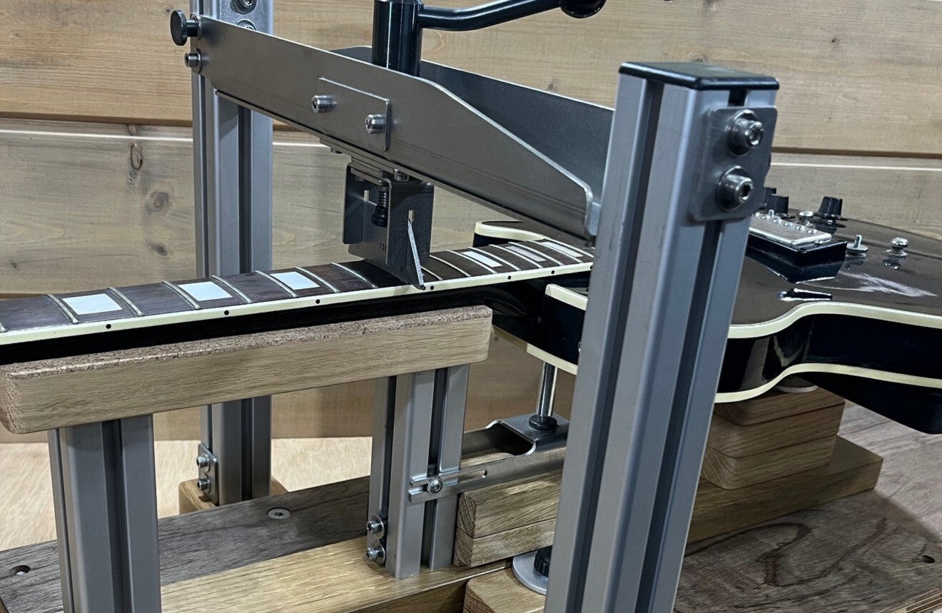 GMC Luthier Tools Full Guitar Fret Press & Cradle shown pressing frets at the transition area on a vintage 1970's les paul guitar.