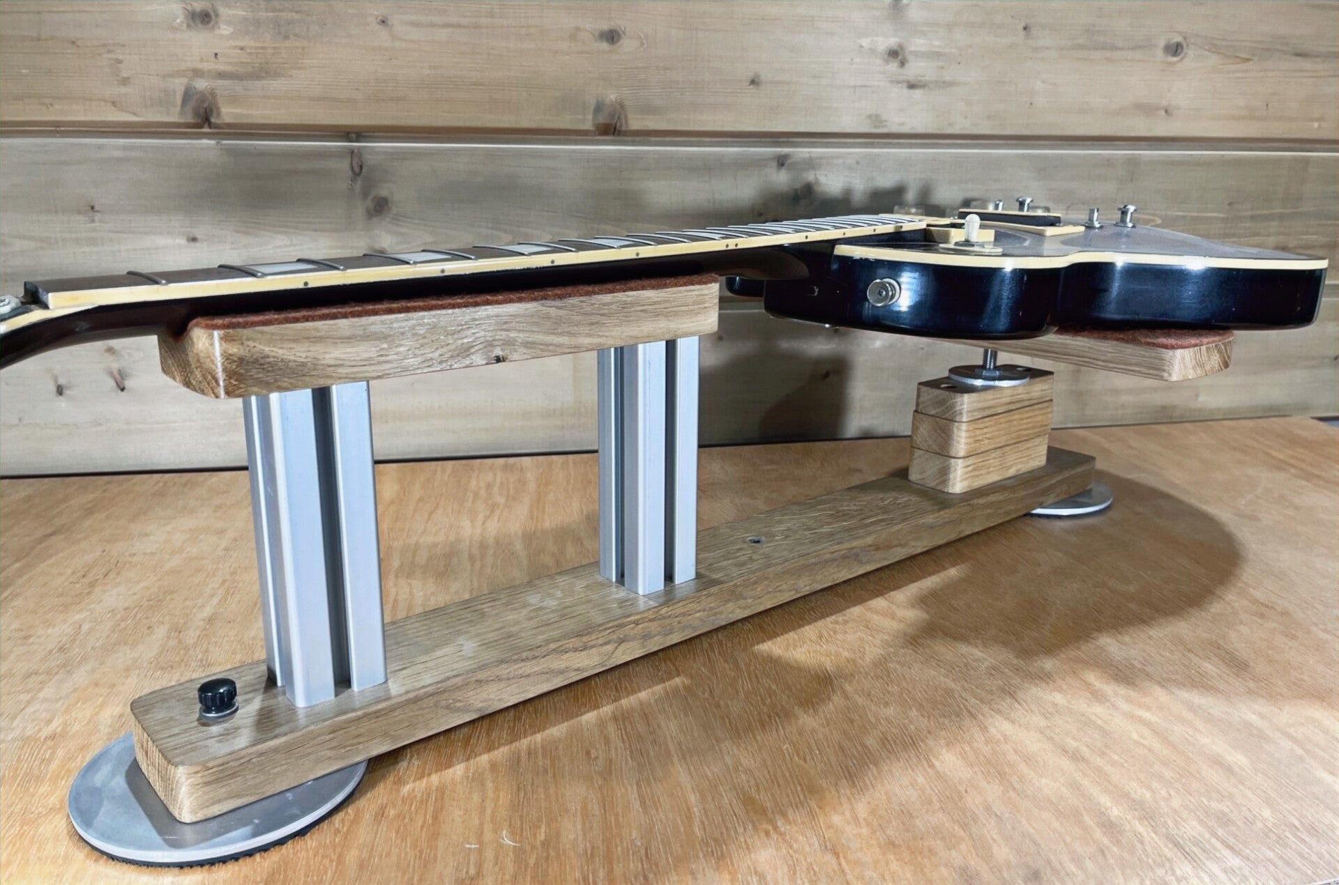 GMC Luthier Tools Guitar benchrest/Cradle on a workbench with a lespaul guitar resting on it.