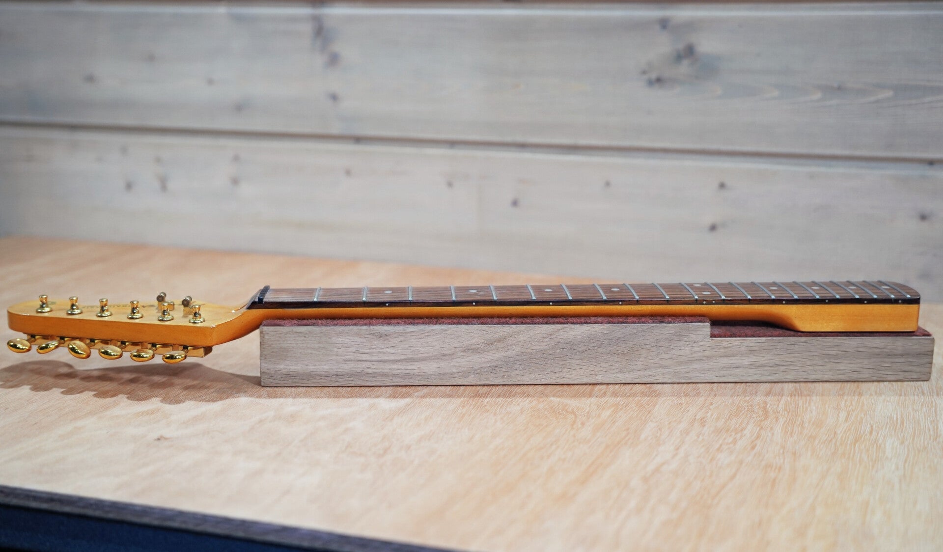 GMC Luthier Tools Full Neck Length Caul with a vintage finished stratocaster neck placed on it.