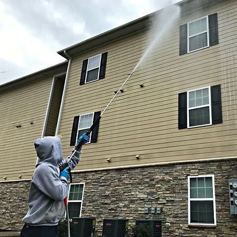 Apartment complex soft washing service restoring exterior siding and common areas.