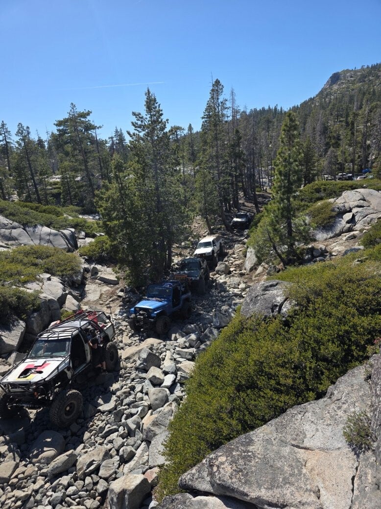 Four rigs picking through the rocks on a guided Boswell trail run
