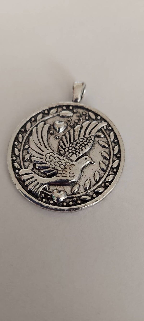 Geluks amulet met vredesduif