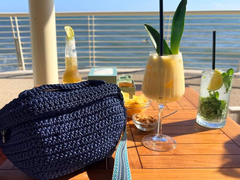 Coctail at the beach with crochet bag