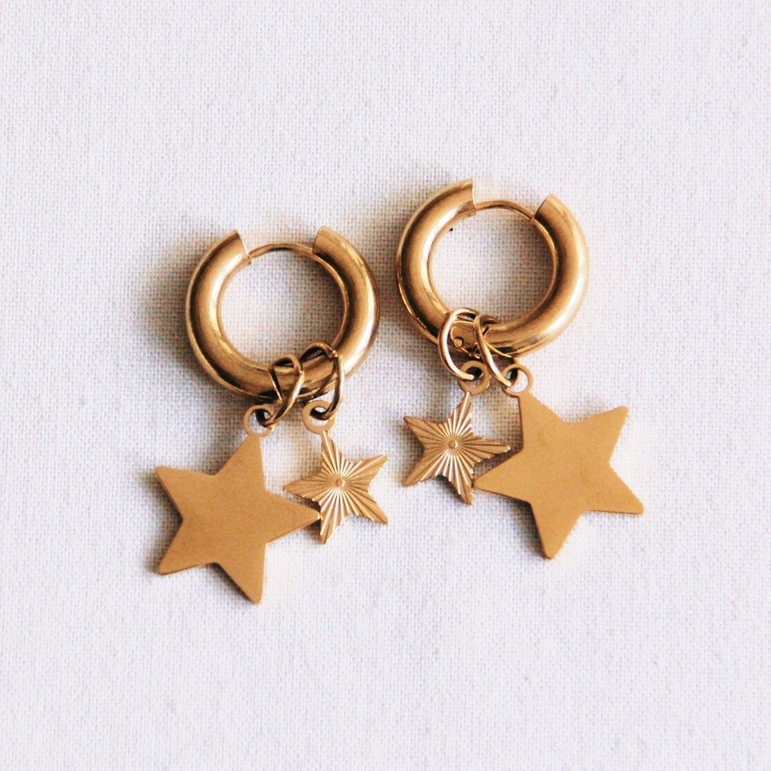 Brede creool met fantasie en grote ster - goud