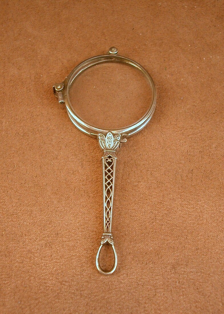 Paire de binocles dépliantes, face à main ancien en argent massif