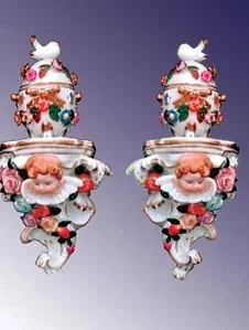 Pair of Dresden porcelain wall ornaments with flowers and cherubs