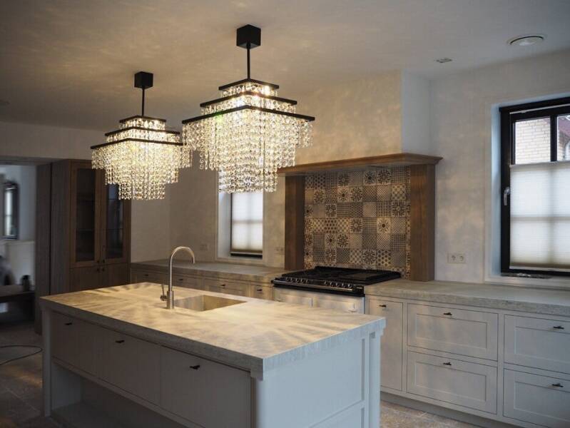 modern crystal chandelier installation in contemporary kitchen