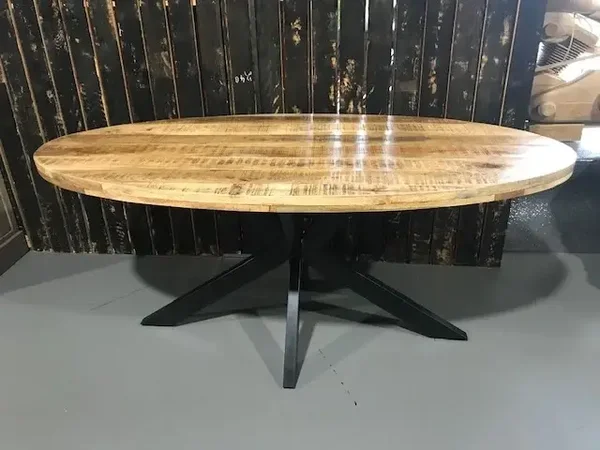 Eetkamertafel in mangohout , ovaal, met metalen kruispoot.