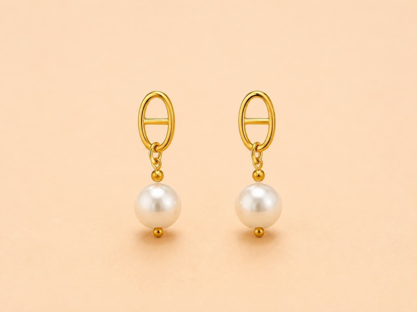 Boucles d'oreilles dorées ovales et perle pendante