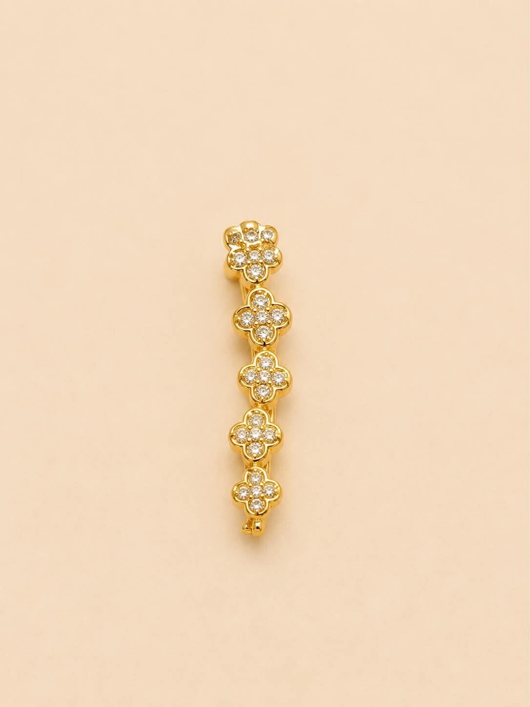 Boucle d'oreille unique en arc fleuri serti de strass Doré