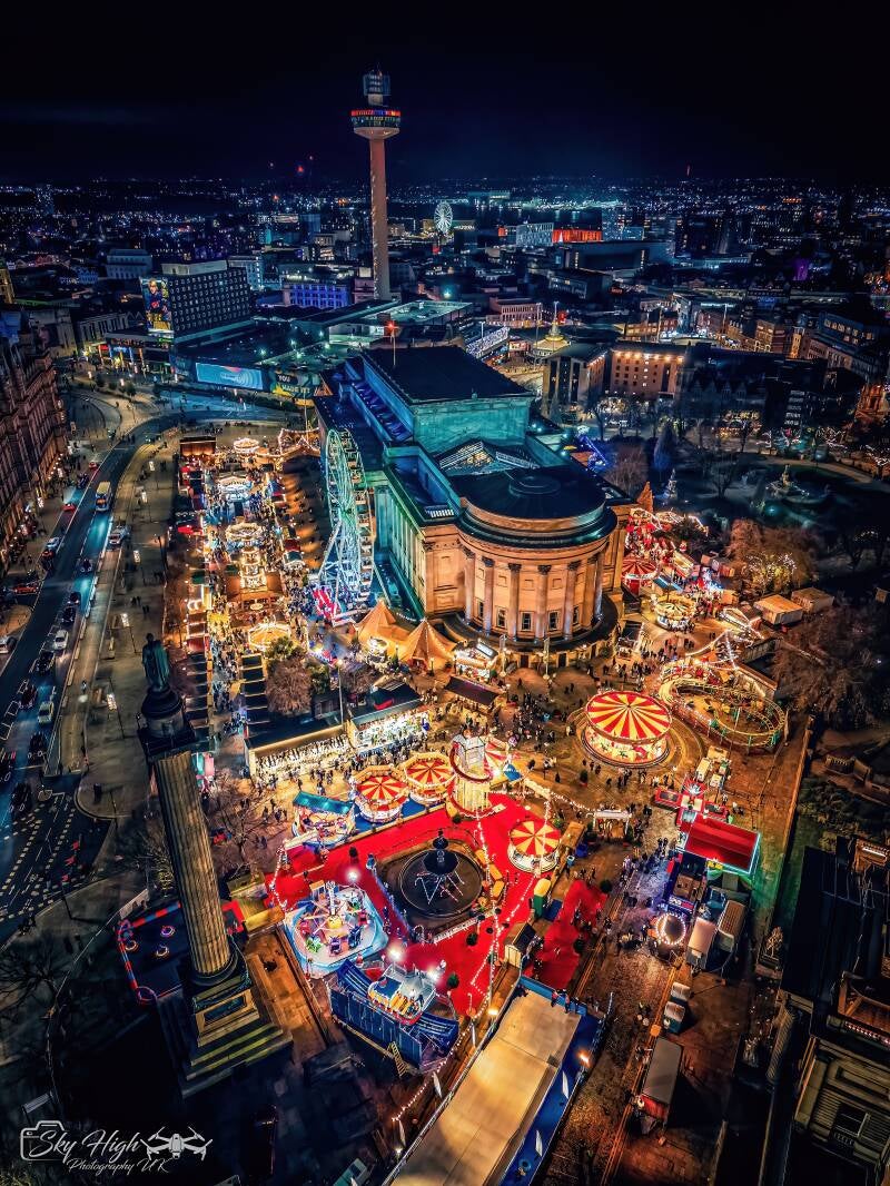 Aerial night photograph of Liverpool’s Christmas market surrounding St George’s Hall, with St Johns Beacon in the skyline, by Mike McMahon.