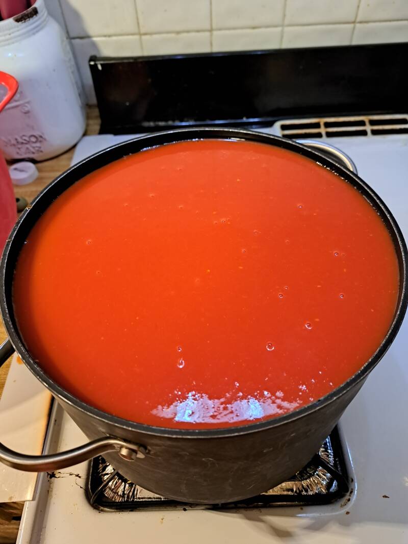 a stock pot that was too small, about to overflow with tomatoes!