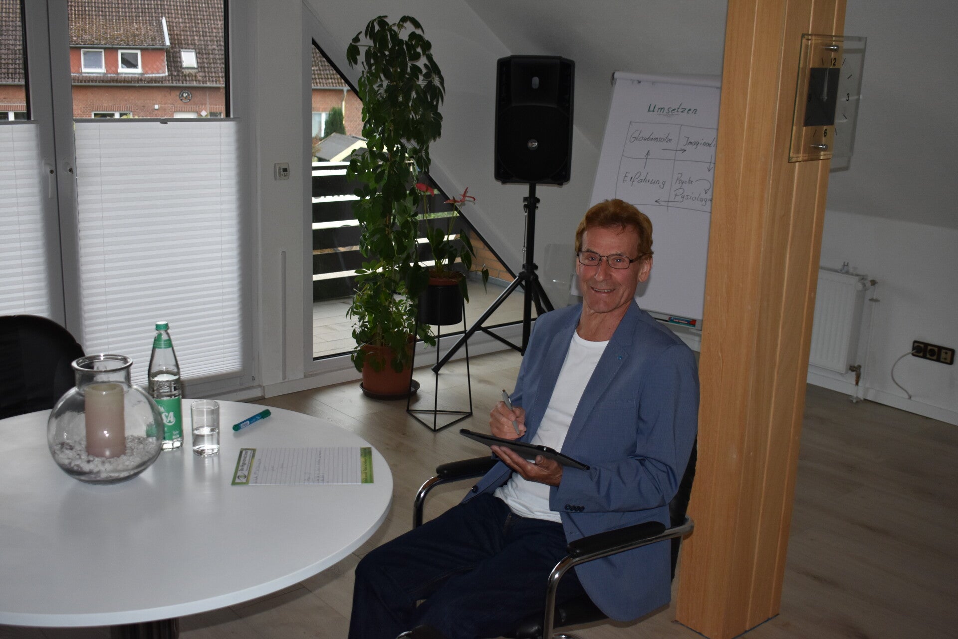 Hypnosecoach sitzt in modernem Coachingraum und führt Beratungsgespräch