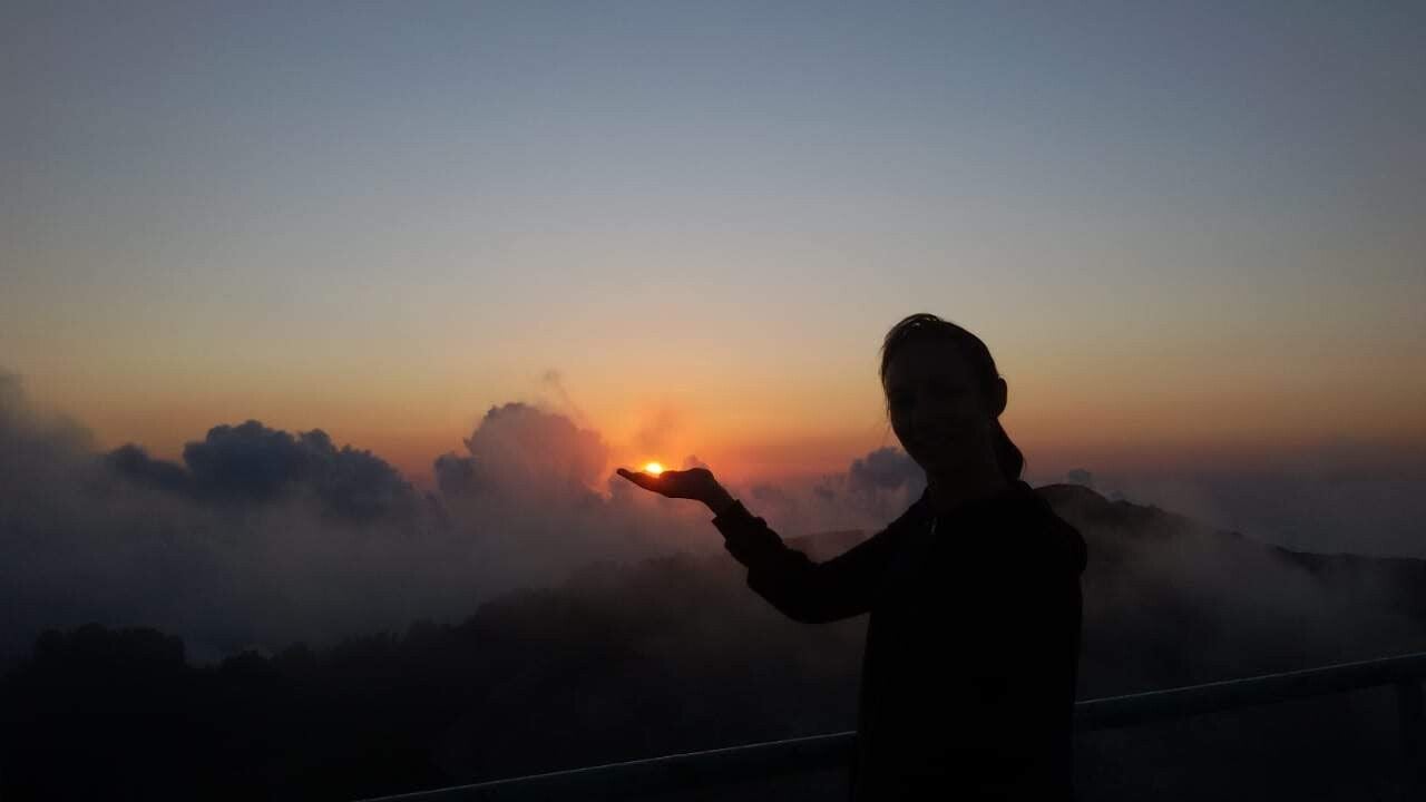 sunset beach scene with three women talking together, symbolising connection and community
