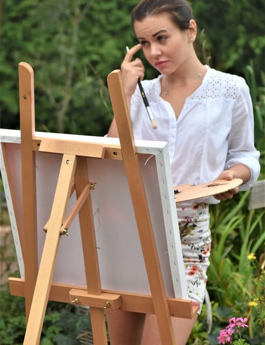 Woman painting on canvas