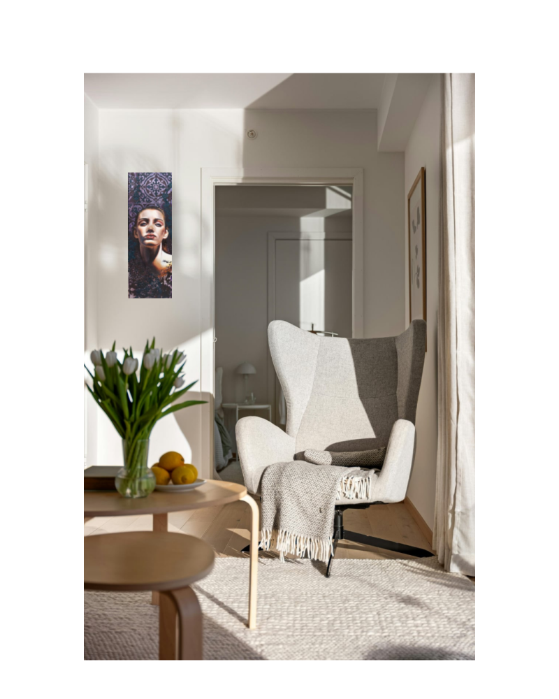 Painting by Annalisa mongio called Resilience. Showing a woman looking at the viewer . The painting is showed cases in a living room 