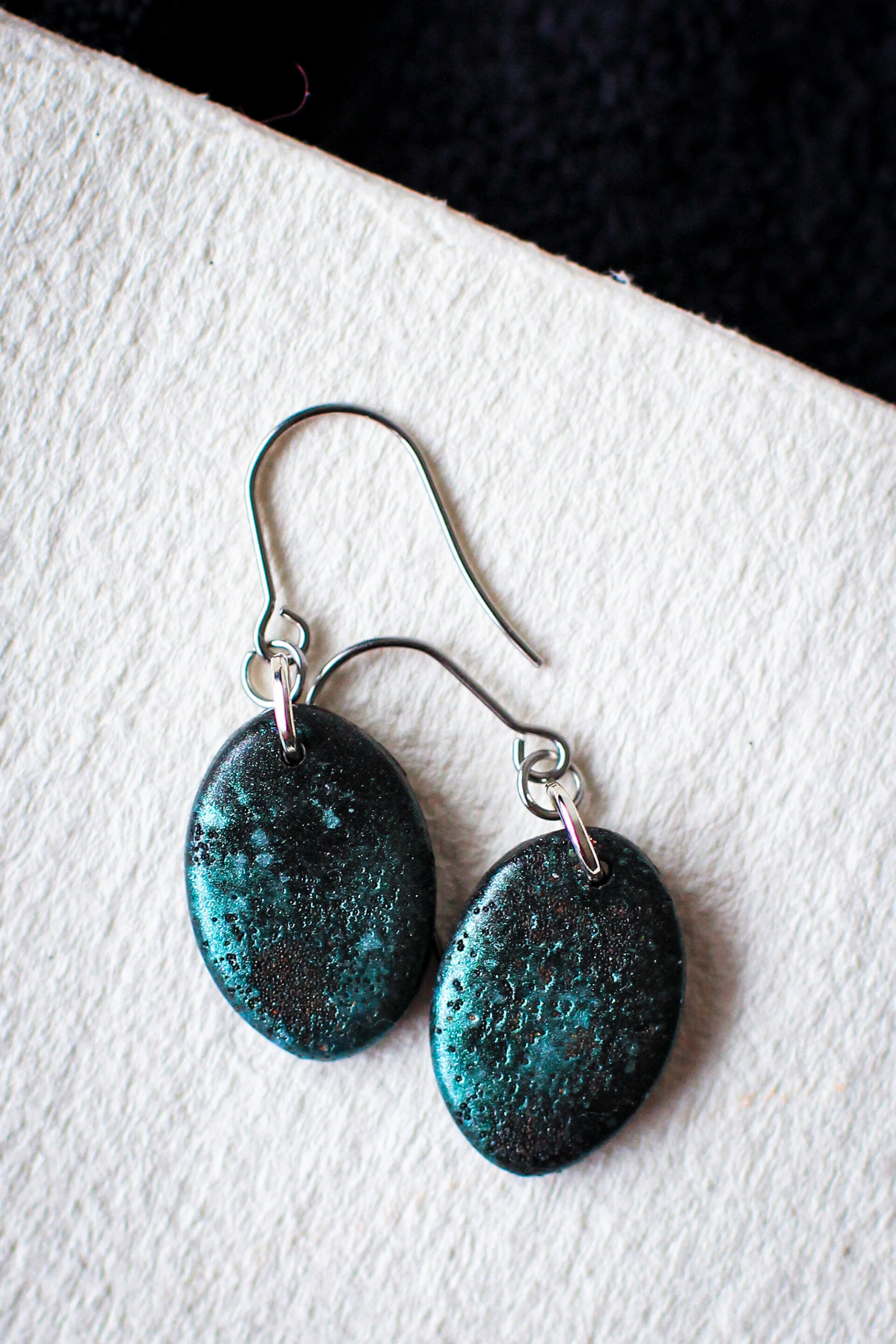 Small oval weathered metallic dangles