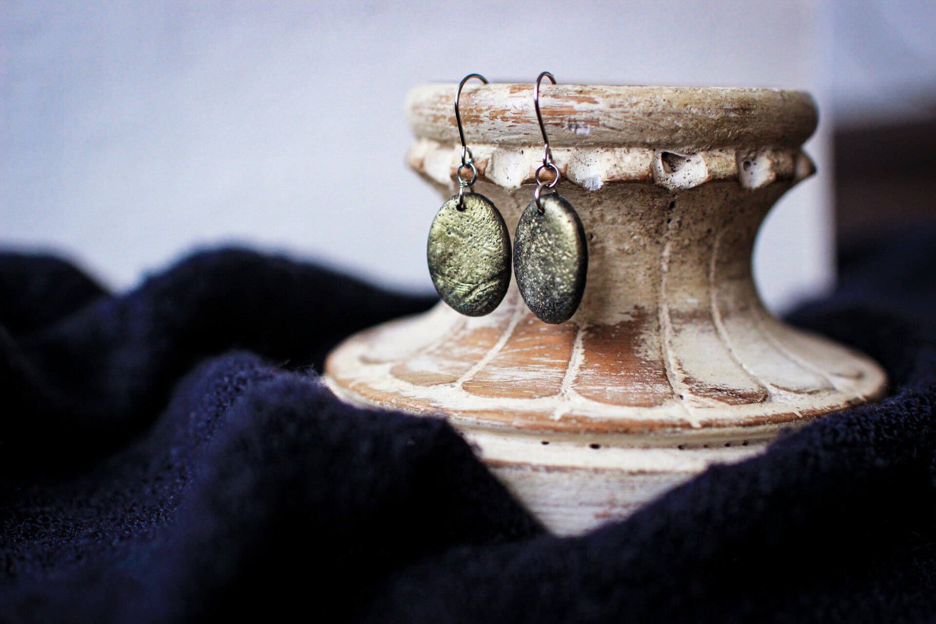 Antiqued golden oval dangles