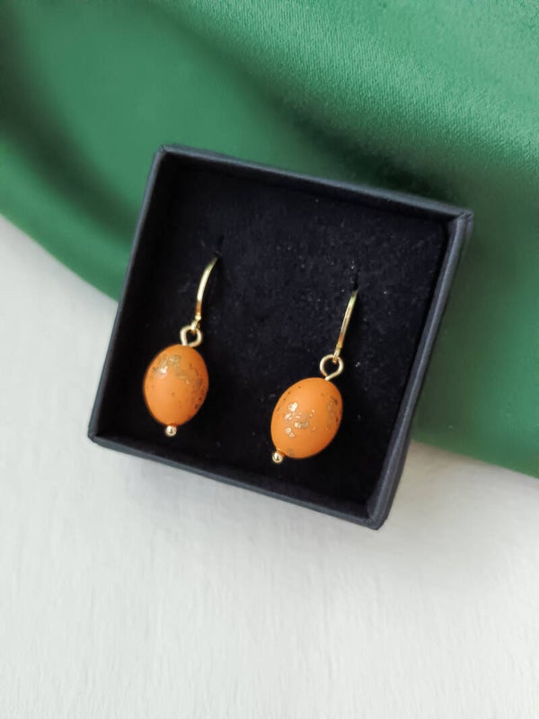 Small oval beaded orange earrings