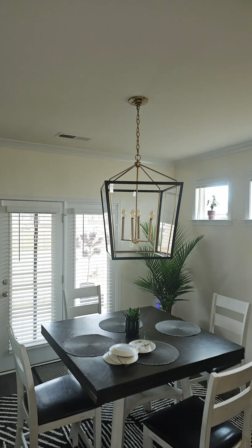 Rectangular lantern chandelier centered above a dining room table