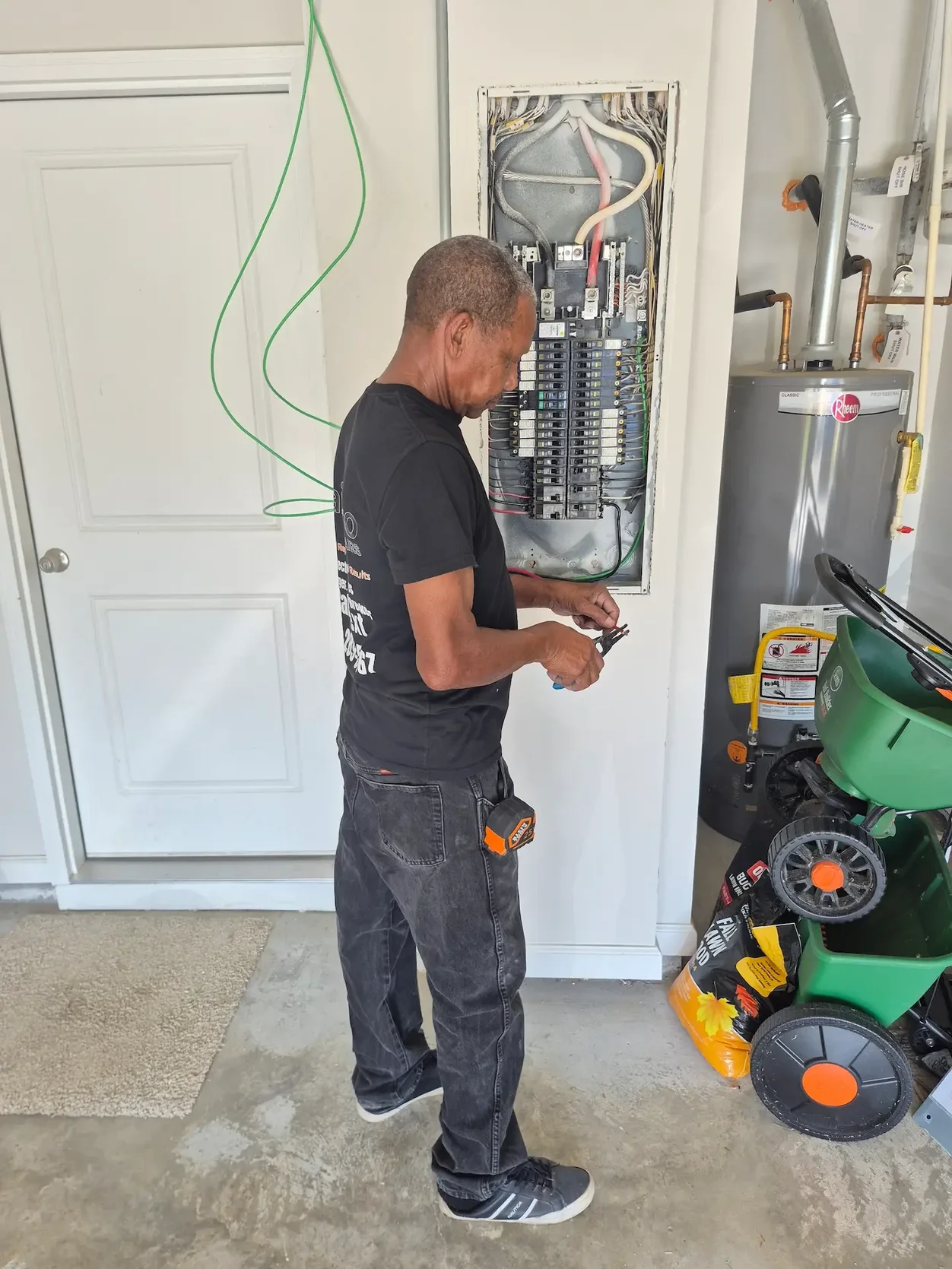 Kais Pro Repairs technician working at the electrical panel on a new 60 amp EV charging circuit