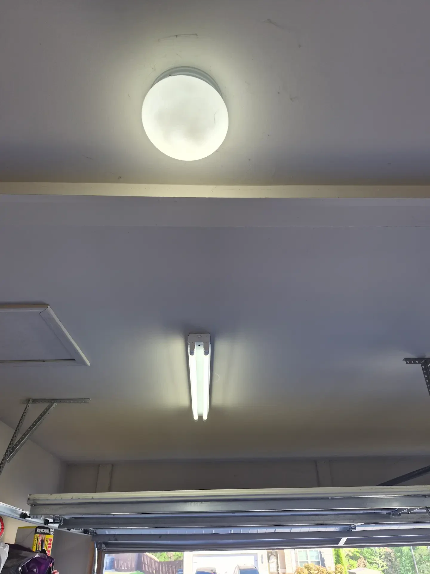 Garage lighting installed in Loganville GA by Kais Pro Repairs with two new lights and motion sensor switch